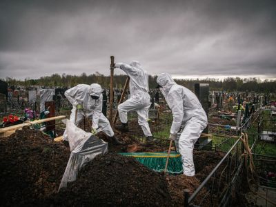 Бригада опускает в могилу тело пожилой женщины, болевшей COVID-19 и онкологическим заболеванием Фото: Вадим Брайдов / Такие дела